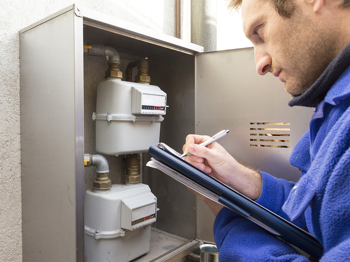 gas meter reader writing down numbers