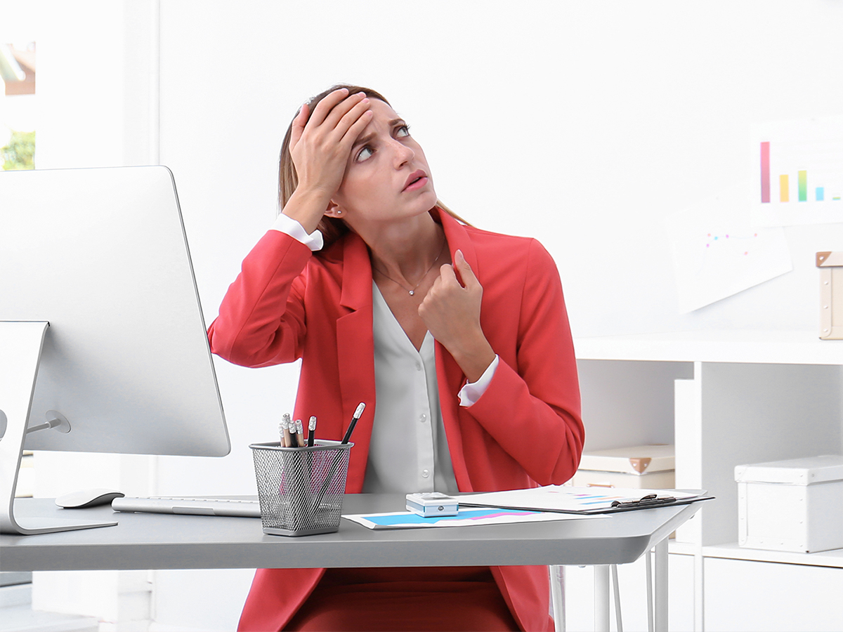 woman in home office annoyed by the heat
