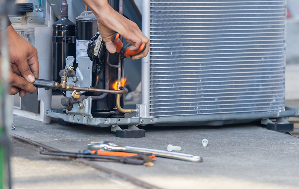 repair man fixing firnace