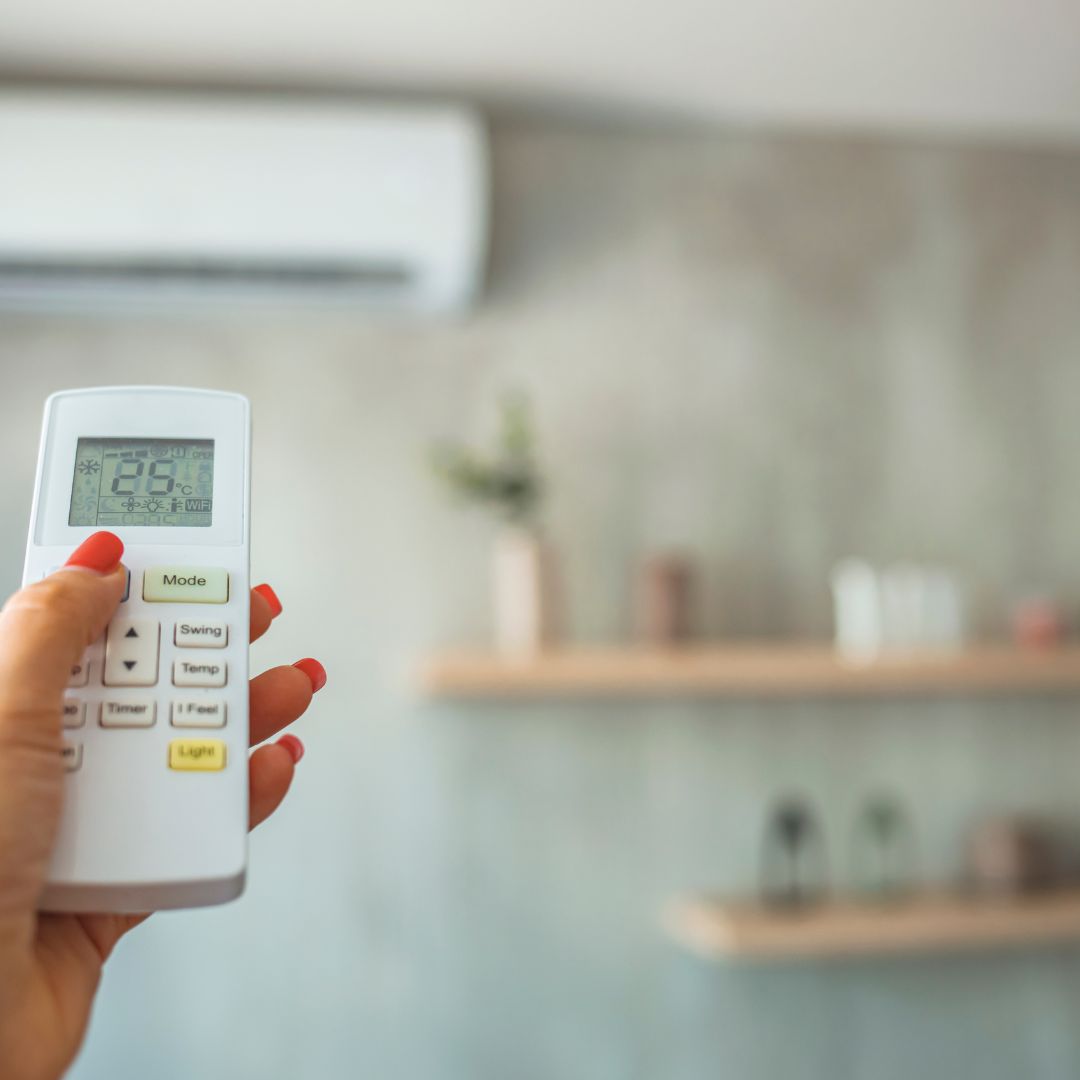 person controlling thermostat 