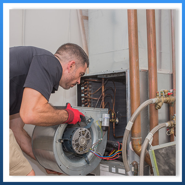 man servicing an hvac system