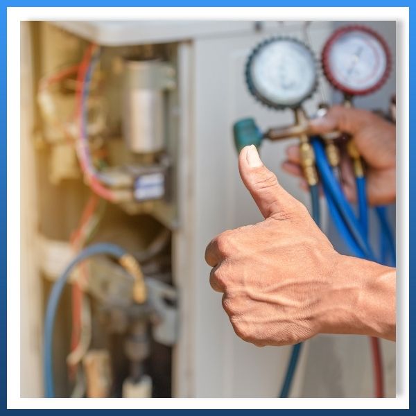 close up of an hvac service provider giving a thumbs up after maintenance