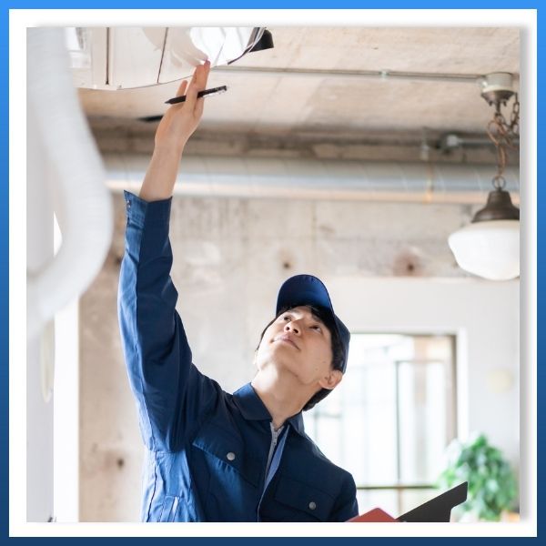 HVAC tech inspecting mini split unit