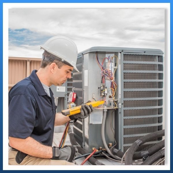 a technician checking an AC unit